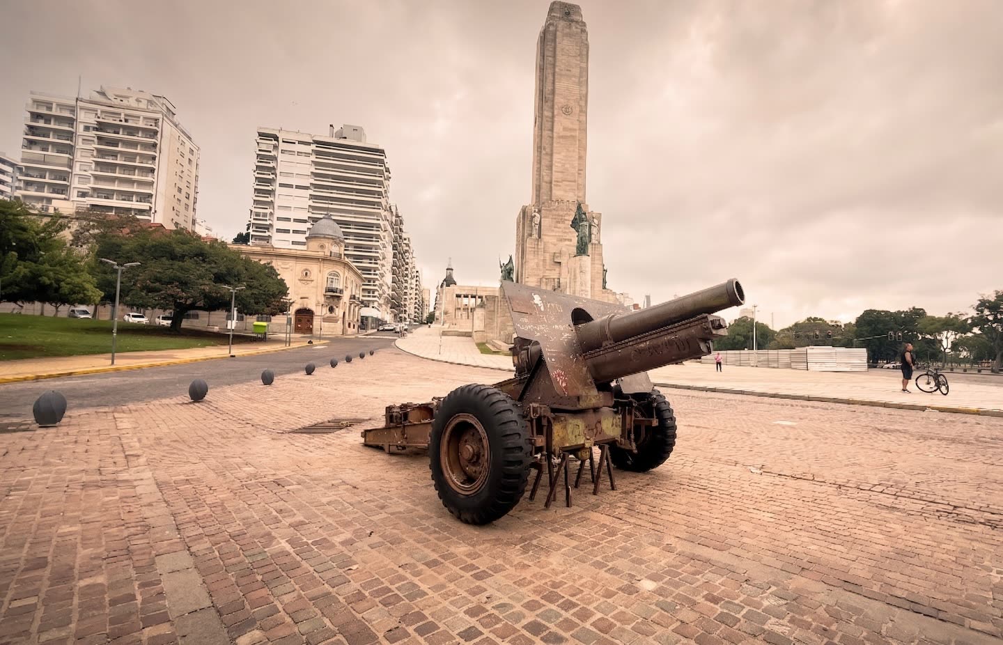 Monumento con obelisco y cañón antiguo en una plaza