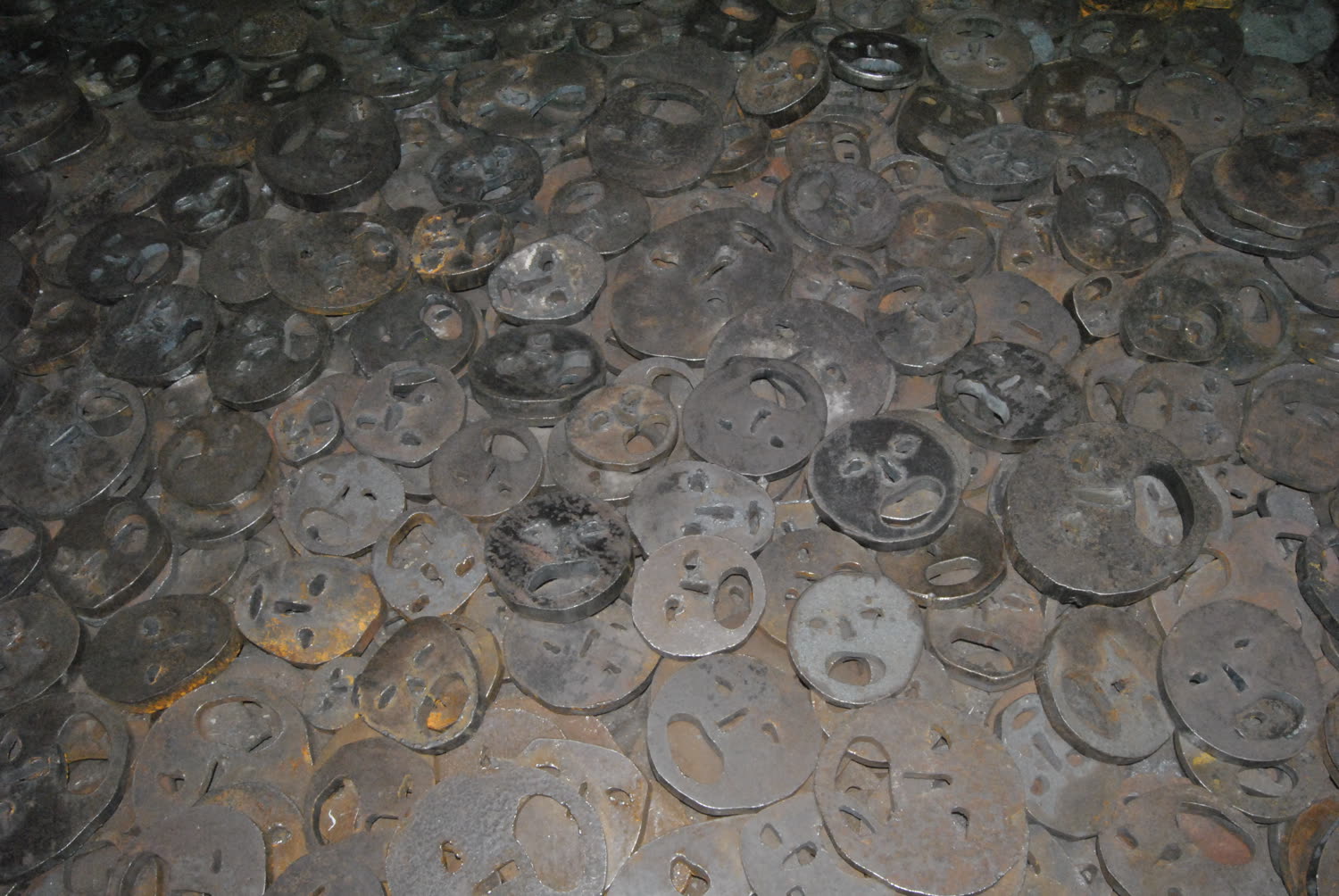 Placas de hierro con rostros tallados, instalación memorial Hojas Caídas del Museo Judío de Berlín